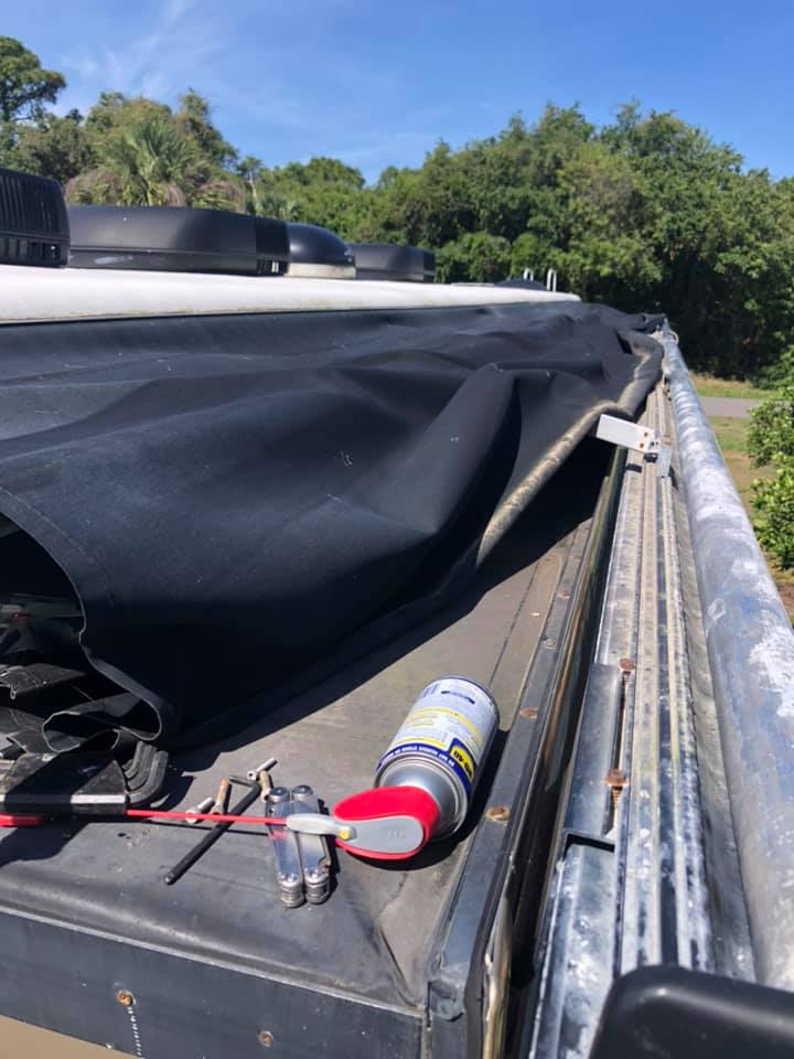 Old awning fabric being removed for replacement