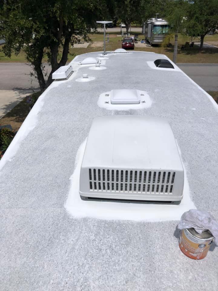 RV roof reseal in progress around rooftop A/C unit
